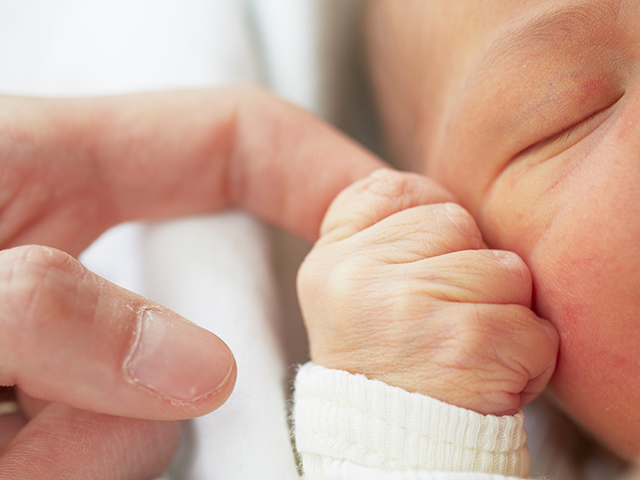 Newborn baby with father - selective focus